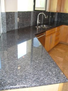 Black granite countertop with sink—Tucson granite surface cleaning and shine restoration.